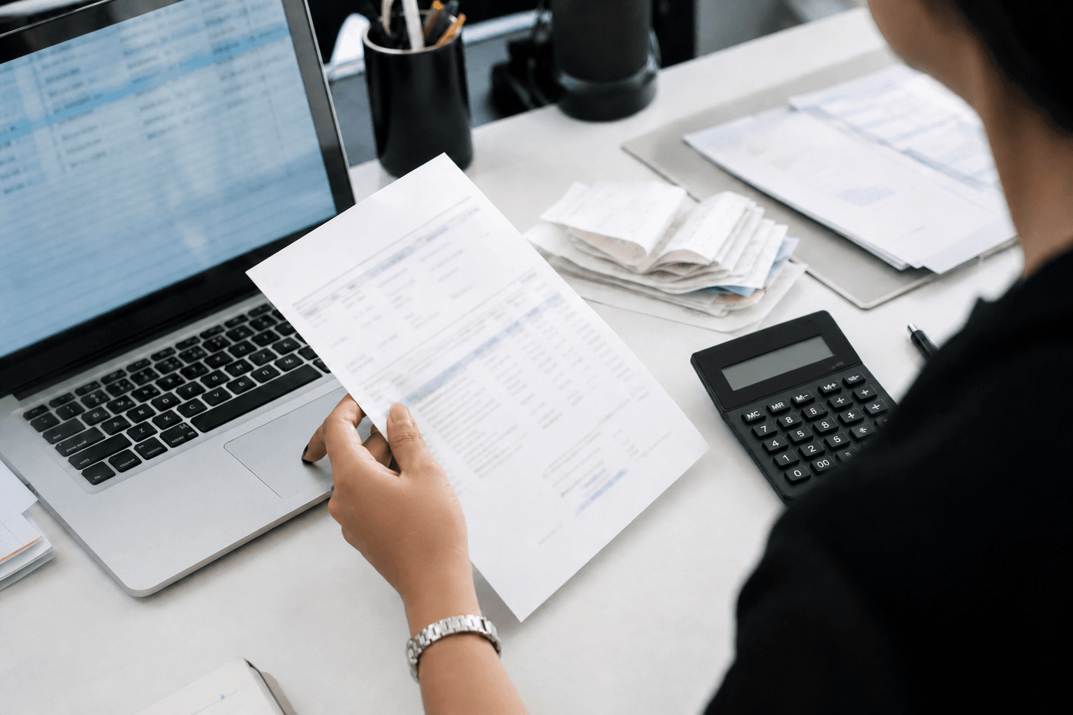 An employee processing invoices on a laptop
