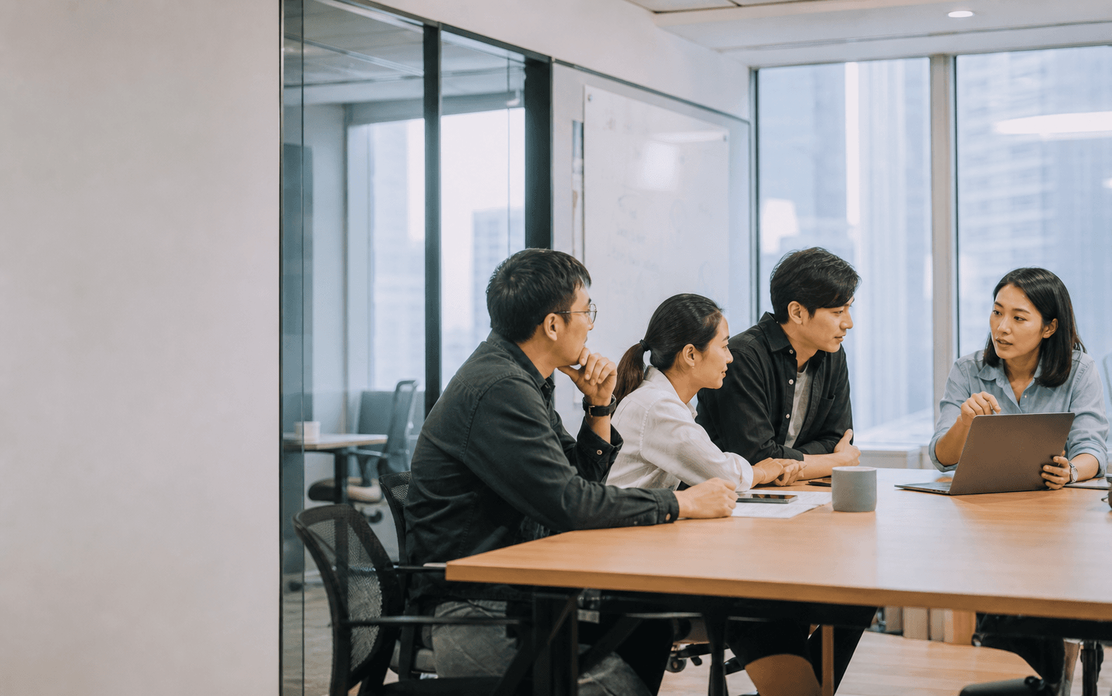 A business team taking part in hands-on AI training in a Hong Kong office